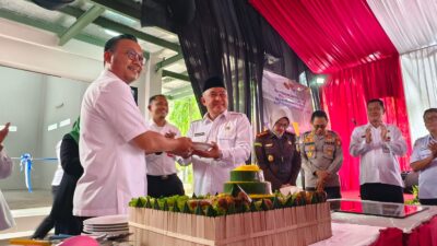 Kepala BPN Kota Depok Indra Gunawan menyerahkan potongan tumpeng yang diserahkan ke Wali Kota Depok Mohammad Idris saat peresmian gedung arsip, Rabu 24 Januari 2024.